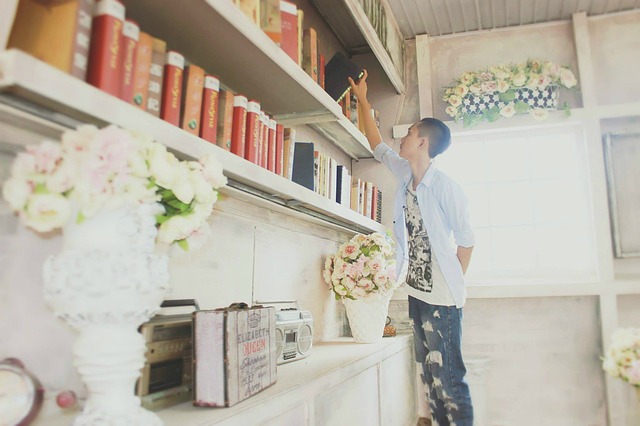 boy selecting book from library